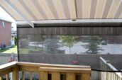 a view of a back yard from a screened porch