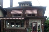 a building with drop arm awnings over the windows