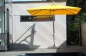 a sidepost umbrella in a backyard patio