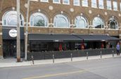 a restaurant with red umbrellas on the outside